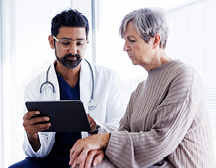Provider talking with elderly patient